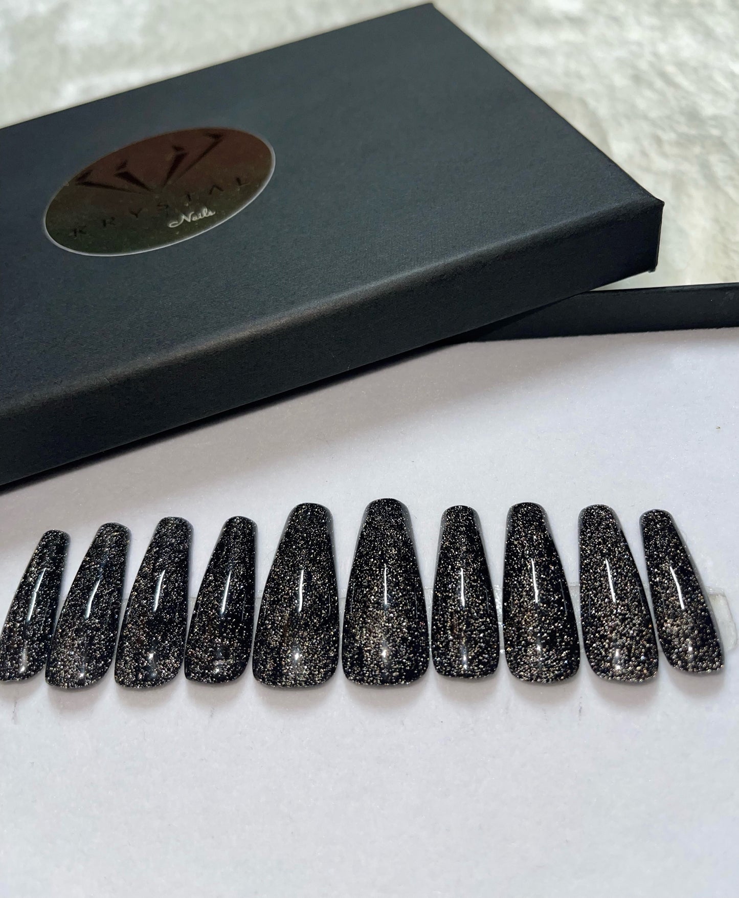 A deep black with reflective glitter. If you are looking for black nails with sparkle, this set is for you!  Shape pictured: Long coffin