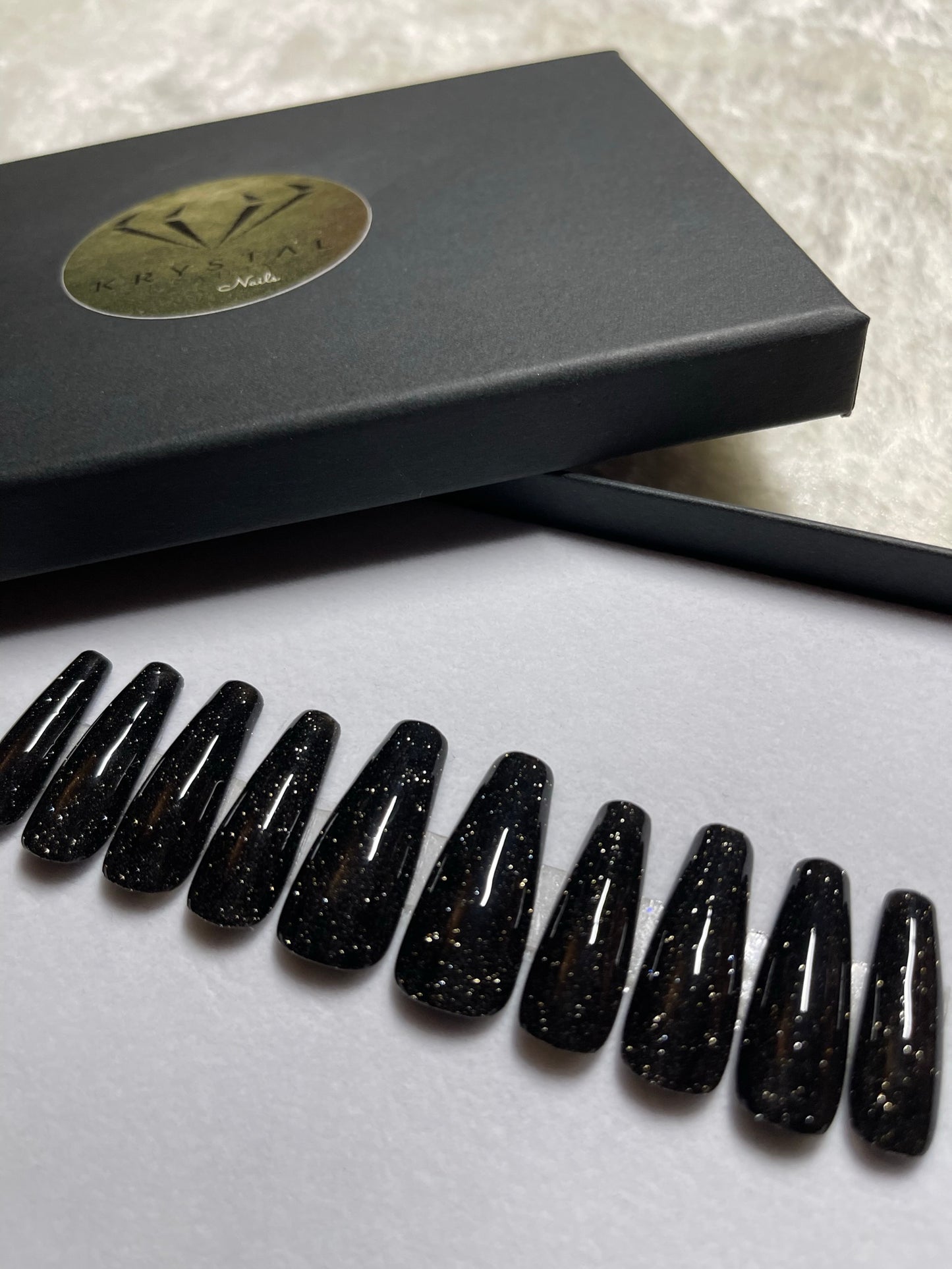 A deep black with reflective glitter. If you are looking for black nails with sparkle, this set is for you!  Shape pictured: Long coffin